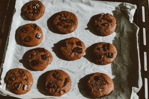 Delicious homemade chocolate chip cookies freshly baked and cooling on a tray.