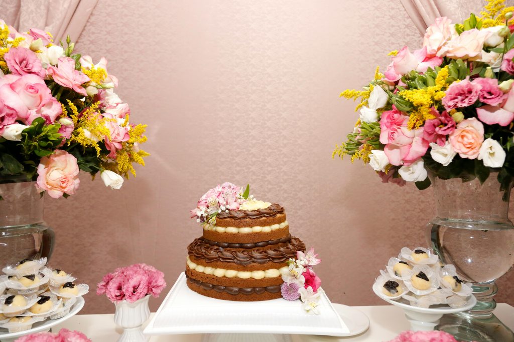 Beautifully decorated cake with vibrant floral arrangements for a special occasion.